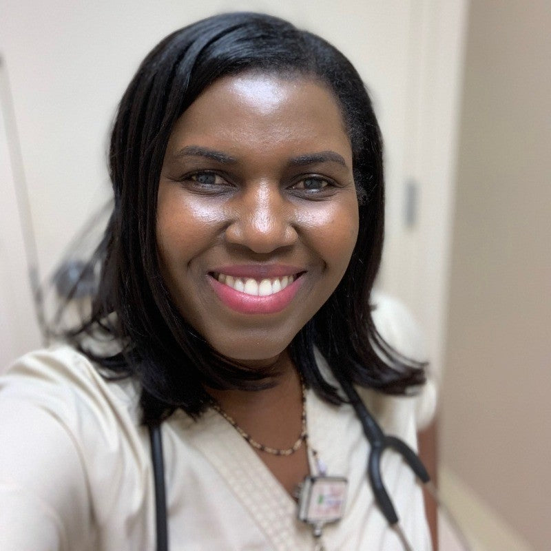 Widlaine Casseus, founder of Bright Care Academy, smiling with a stethoscope around her neck.
